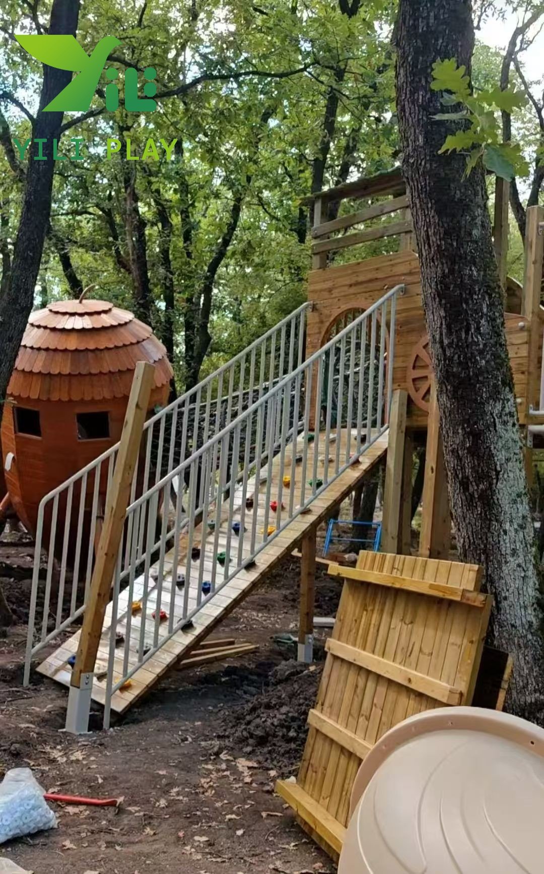 European pinecone outdoor playground with natural wooden cabins, rope bridges, and climbing structures